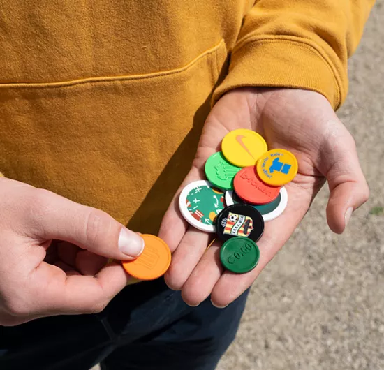 Person holding personalised Tokens with sportive designs